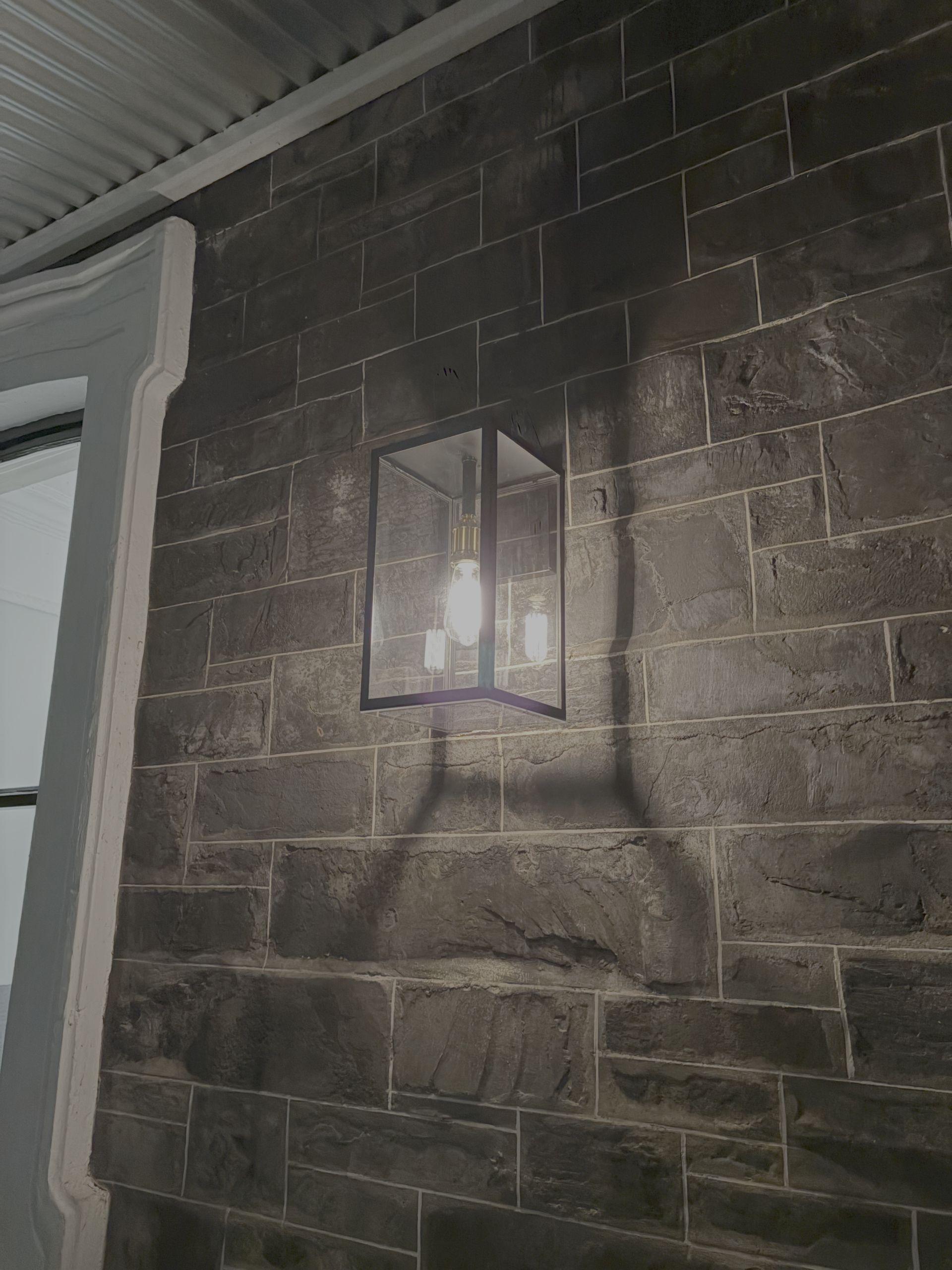 Glass pendant light on black wall