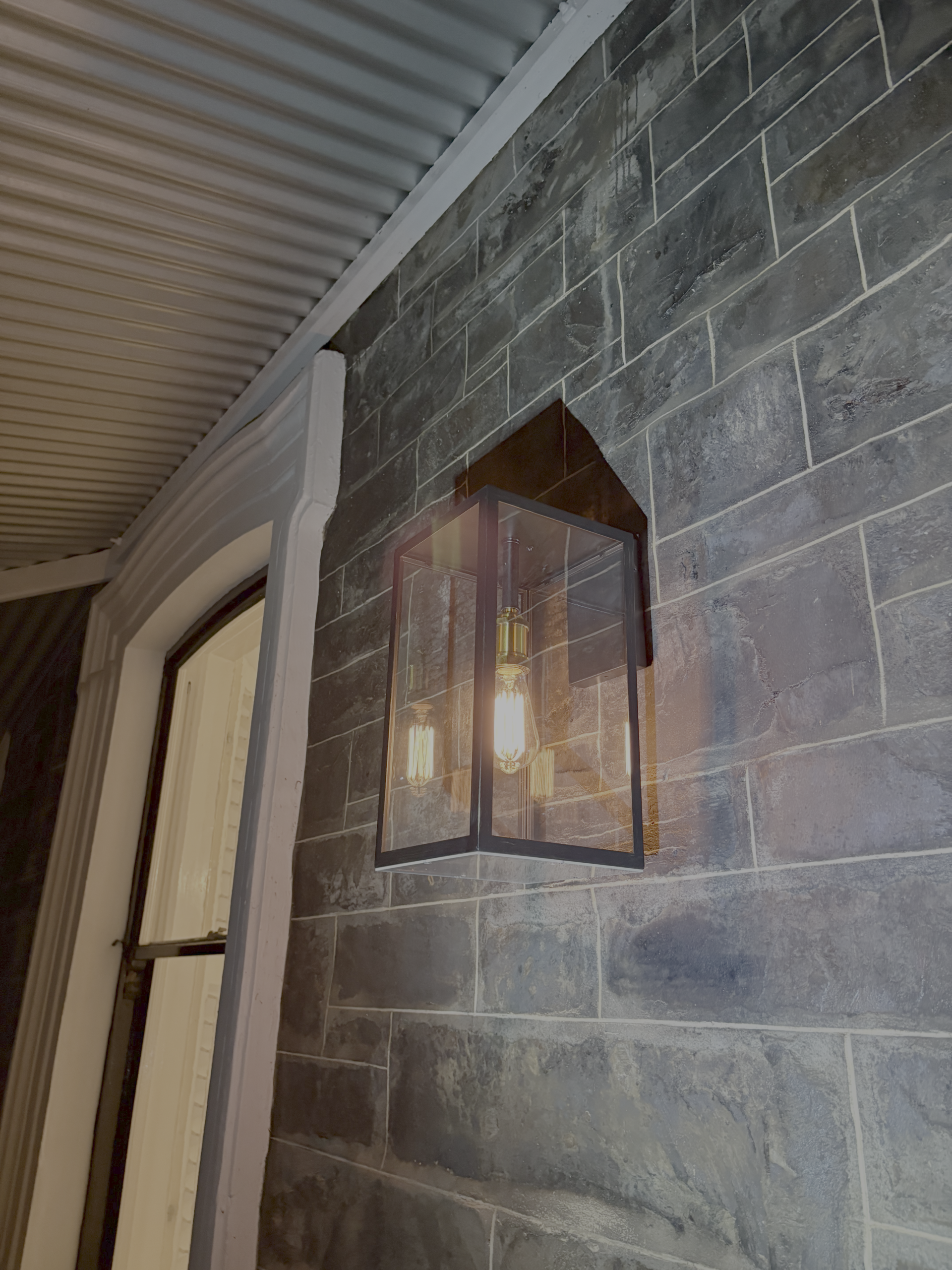 Glass pendant on brick wall