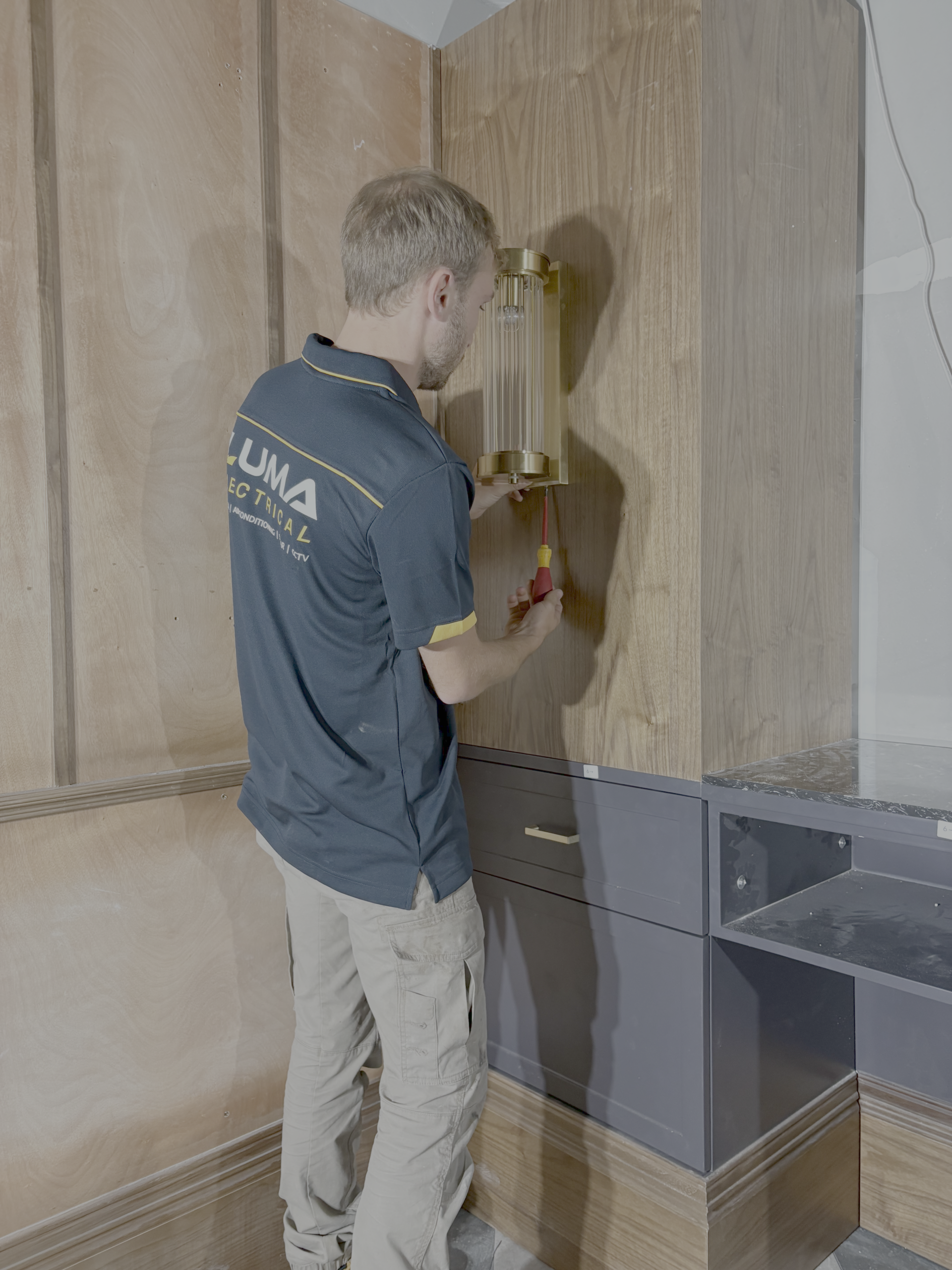 Luma electrical emplyee installing wall light